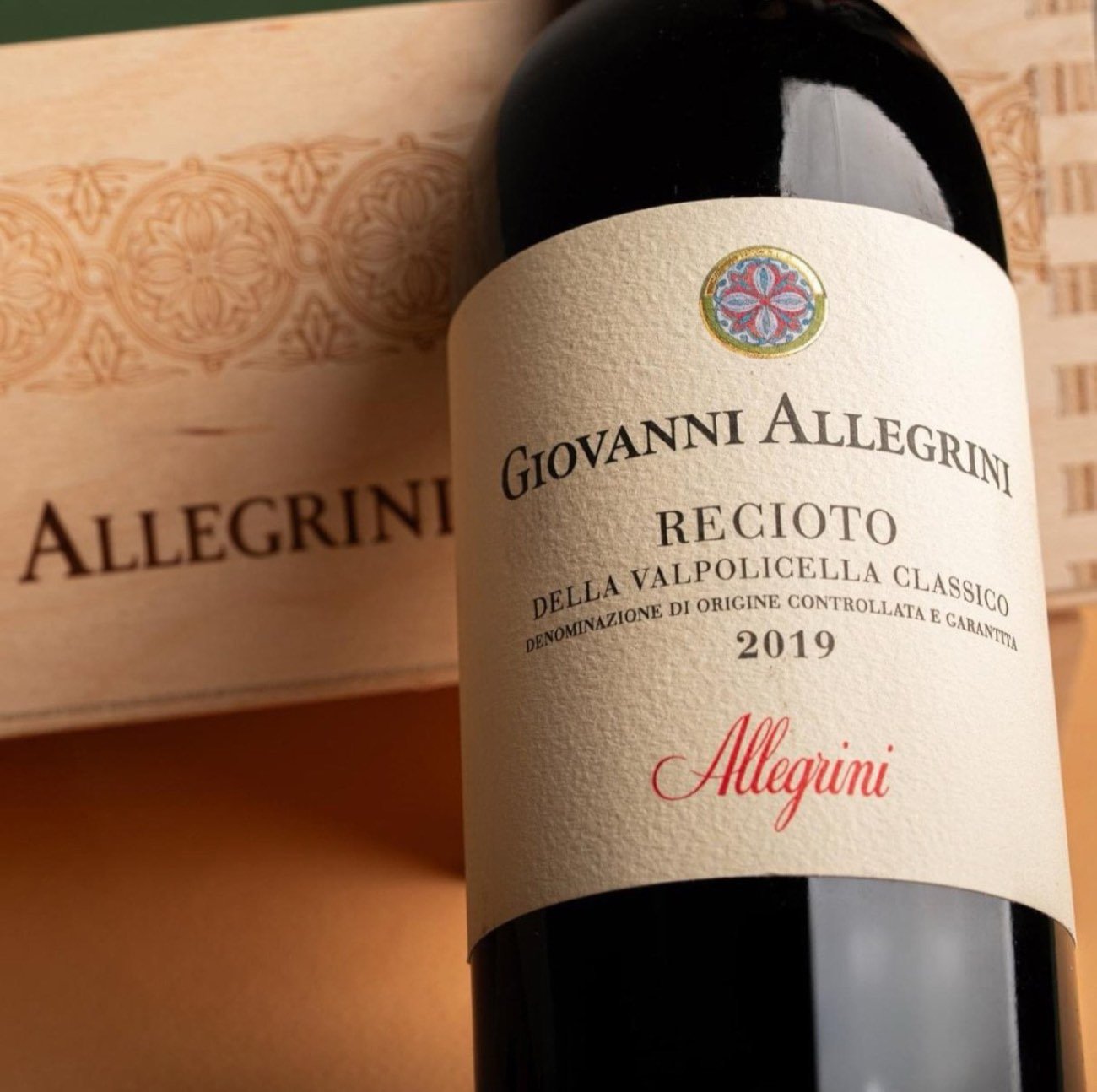 A bottle of Giovanni Allegrini Recioto della Valpolicella Classico in front of a wooden case
