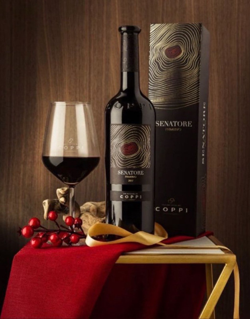 A Senatore bottle from Coppi presented in its gift box beside a filled glass